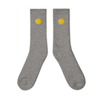 Crew socks, outside view, heather grey, "Egg Yolk" embroidery on both socks