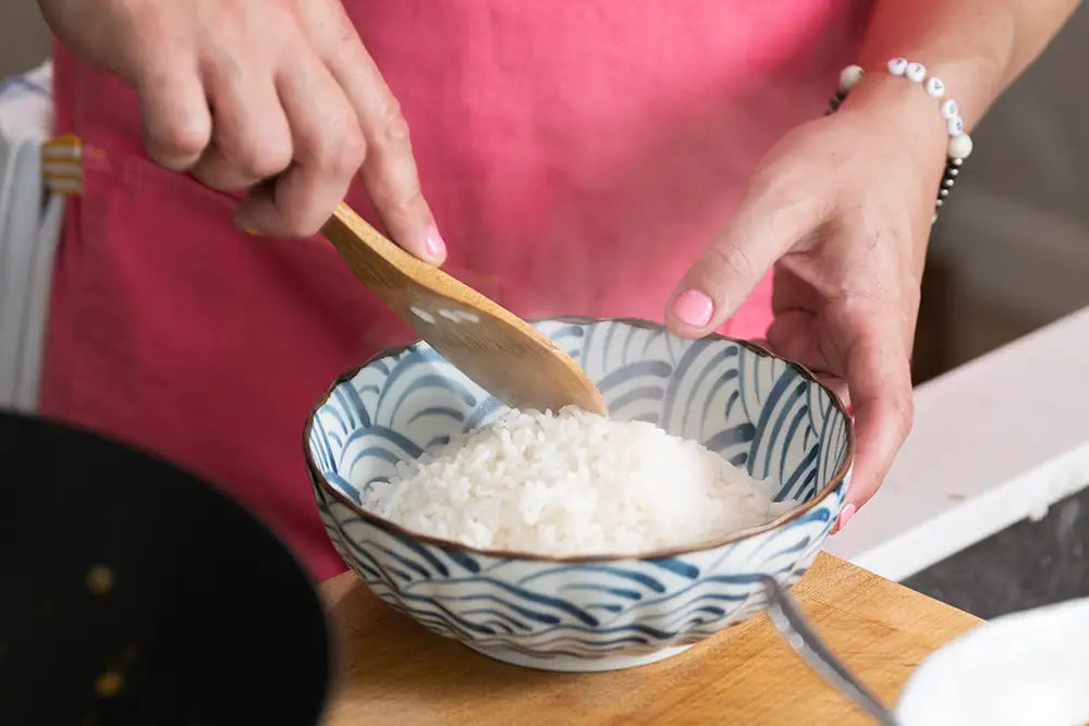 Kenji López-Alt serving a bowl of steaming rice.