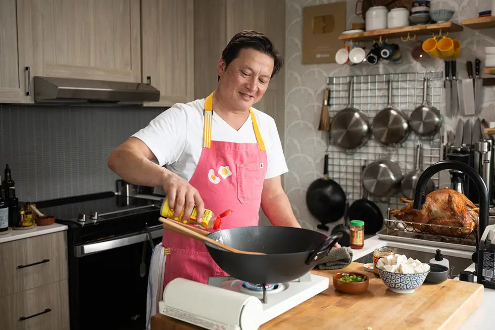 Kenji López-Alt cooking with his collaboration Our Place wok.